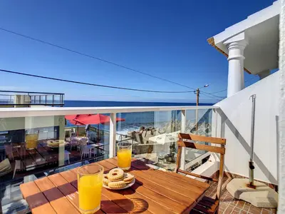 a balcony with a table with glasses of orange juice at Casa Safira by LovelyStay in Paul do Mar