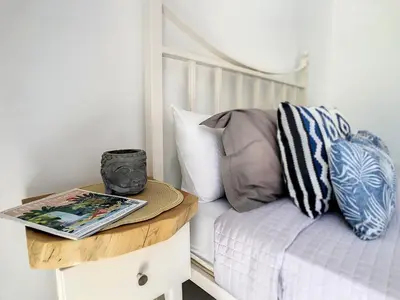 a bed with a table with a book on it at Casa Safira by LovelyStay in Paul do Mar