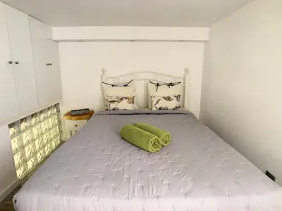 a white bed with a green towel on it at Casa Safira by LovelyStay in Paul do Mar