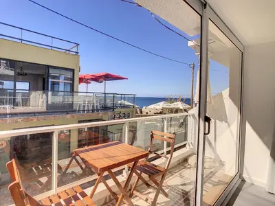 a balcony with a table and chairs and the ocean at Casa Safira by LovelyStay in Paul do Mar