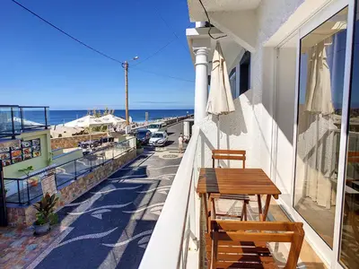 a balcony with two chairs and a table on a building at Casa Safira by LovelyStay in Paul do Mar