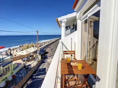 a balcony with a table and a view of the ocean at Casa Safira by LovelyStay in Paul do Mar