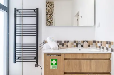 a bathroom with a sink and a mirror at Villa Camelia in Arco da Calheta