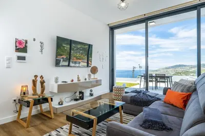 a living room with a view of the ocean at Villa Camelia in Arco da Calheta