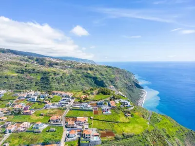 an aerial view of a village on a hill next to the ocean at Villa Camelia in Arco da Calheta