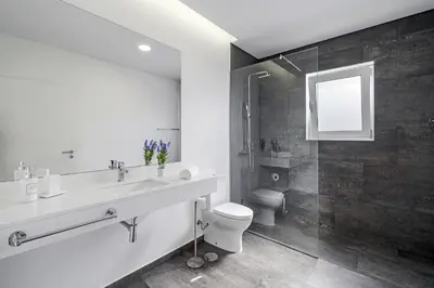 a bathroom with a sink and a toilet and a shower at Villa Calhetascape by Villa Plus in Estreito da Calheta