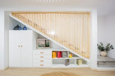 a staircase in a room with white walls and white cabinets at Casa Lugos in Funchal