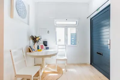 a room with a table and chairs and a blue door at Casa Lugos in Funchal