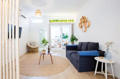 a living room with a blue couch and a table at Casa Lugos in Funchal