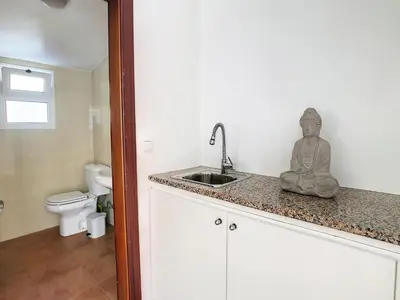 a statue of a buddha sitting on a counter in a bathroom at Naya Beach House by LovelyStay in Paul do Mar
