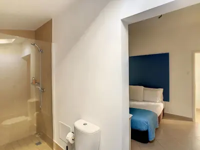 a bedroom with a bed and a bathroom with a shower at Naya Beach House by LovelyStay in Paul do Mar