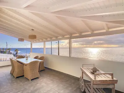 a dining room with a table and a view of the ocean at Naya Beach House by LovelyStay in Paul do Mar