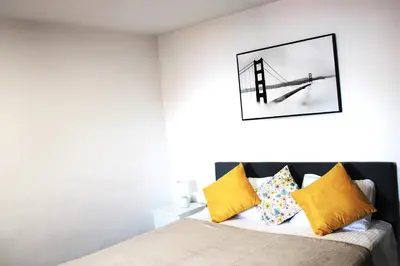 a bedroom with a bed with yellow pillows at Moradia Stephanie in Funchal