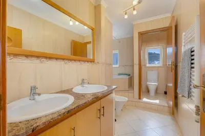 a bathroom with two sinks and a toilet at Good Vibes Villa in Aljezur