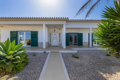 a bedroom with a bed and a mirror at Good Vibes Villa in Aljezur