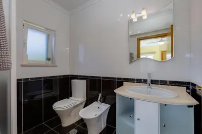 a bathroom with a toilet and a sink at Good Vibes Villa in Aljezur