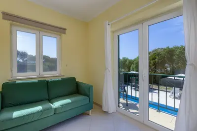 a large white bed with two pillows on it at Good Vibes Villa in Aljezur