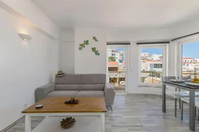 a living room with a couch and a table at Casa Lilas, magnífica vista mar a passos da praia in Luz