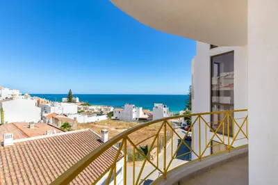 a balcony of a building with a view of the ocean at Casa Lilas, magnífica vista mar a passos da praia in Luz