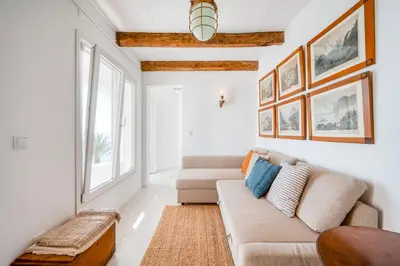 a living room with two couches and a table at Casa da Rocha in Câmara de Lobos