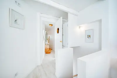 a white hallway with white walls and white floors at Casa da Rocha in Câmara de Lobos