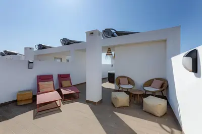 a group of chairs sitting on a patio at Burgau Village and Sea in Burgau
