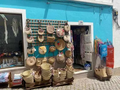 a shop with hats and baskets on display in front of a store at Burgau Village and Sea in Burgau