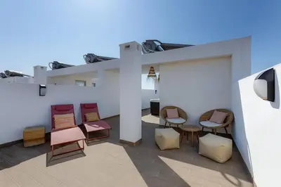 a group of chairs sitting on a patio at Burgau Village and Sea in Burgau