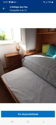 a picture of a bedroom with two beds and a window at O Refúgio dos Pais in Bordeira