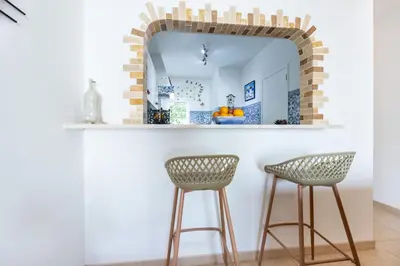 a bar with two stools and a mirror at CoolHouses Algarve, Luz, 1 bed flat, top floor, a stone's throw to the beach, Casa Isabell in Luz