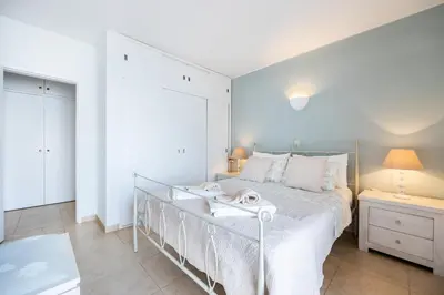 a white bedroom with a bed and two night stands at CoolHouses Algarve, Luz, 1 bed flat, top floor, a stone's throw to the beach, Casa Isabell in Luz