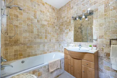 a bathroom with a tub and a sink at CoolHouses Algarve, Luz, 1 bed flat, top floor, a stone's throw to the beach, Casa Isabell in Luz