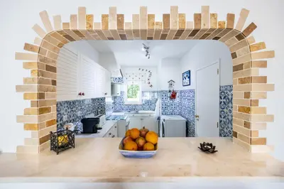 a kitchen with a bowl of fruit on a table at CoolHouses Algarve, Luz, 1 bed flat, top floor, a stone's throw to the beach, Casa Isabell in Luz