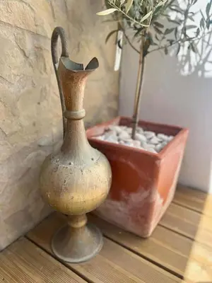 a vase sitting on a table next to a potted plant at Villa O Altinho Carrapateira in Carrapateira
