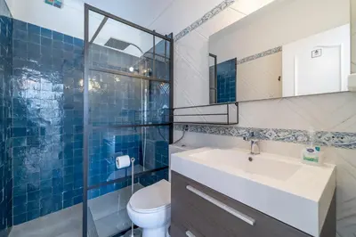 a bathroom with a sink and a toilet at Villa O Altinho Carrapateira in Carrapateira