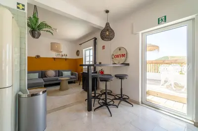 a living room with a couch and a table at Villa O Altinho Carrapateira in Carrapateira
