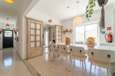 a dining room with a table and chairs at Villa O Altinho Carrapateira in Carrapateira