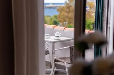 a balcony with a table and two cups of coffee at GuestReady - Sao Tiago in Old Town in Funchal
