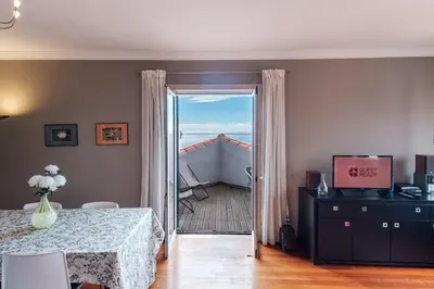 a room with a table and a door to a balcony at GuestReady - Sao Tiago in Old Town in Funchal