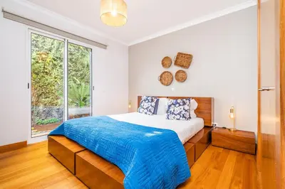 a bedroom with a bed and a large window at Home to Stay by Homie in Funchal