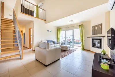 a living room with a couch and a fireplace at Burgau Beach House in Burgau