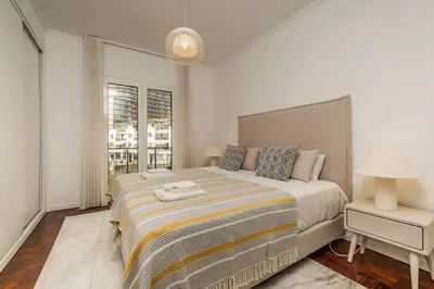 a bedroom with a large bed and a window at Recanto da Princesa by Homie in Funchal