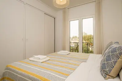 a white bedroom with a bed with towels on it at Recanto da Princesa by Homie in Funchal