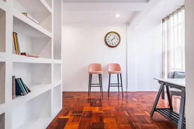 a room with two chairs and a clock on the wall at Recanto da Princesa by Homie in Funchal