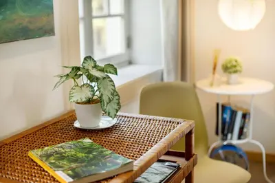 a room with three windows and a table and chairs at Calheta Beach House T1 in Calheta