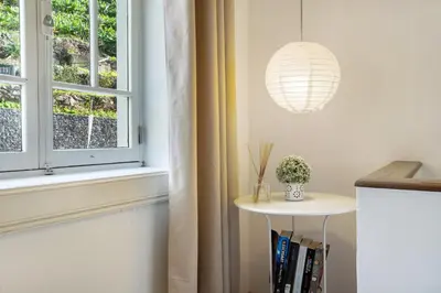a room with a window and a table with a lamp at Calheta Beach House T1 in Calheta