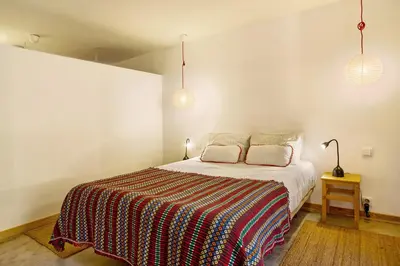 a bedroom with a bed and two pillows on it at Calheta Beach House T2 in Calheta