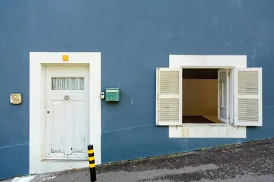 a blue building with two windows and a door at Calheta Beach House T2 in Calheta