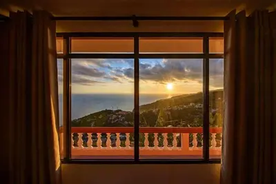 a bath tub on a balcony with a view of the ocean at Lombo Cesteiro Guesthouse in Tábua
