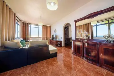 a kitchen and dining room with a table and chairs at Lombo Cesteiro Guesthouse in Tábua